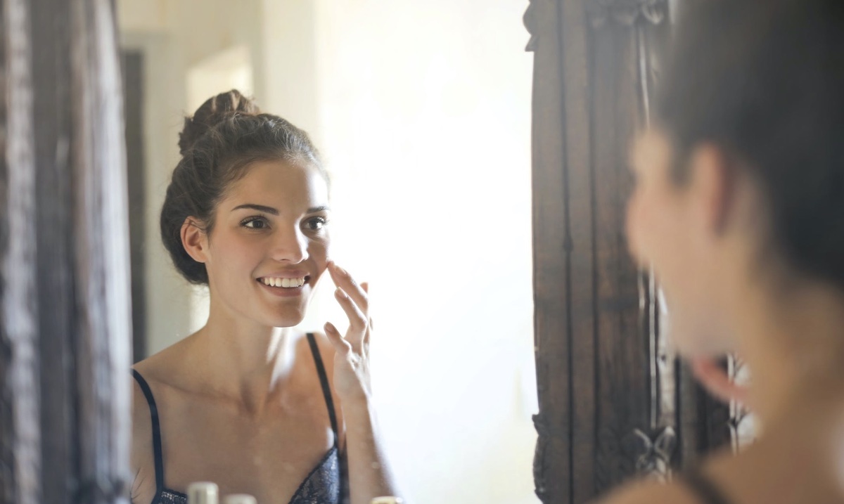Woman looking in mirror. Image: Pexels - Andrea Piacquadio