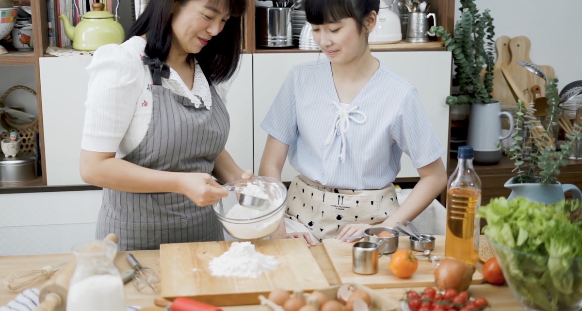 Mom cooking with daughter in kitchen