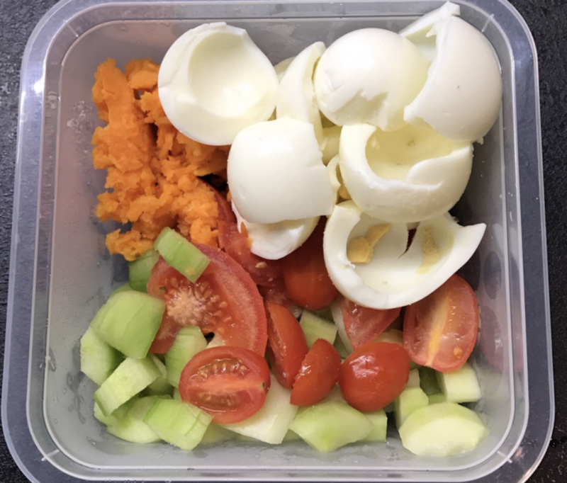 Cucunber, egg, tomato, carrot in tupperware