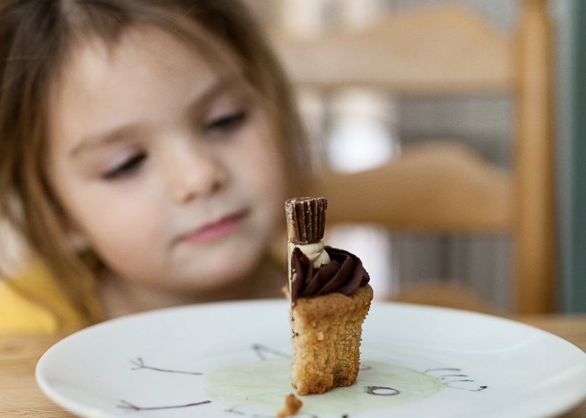 A young girl with a half cake