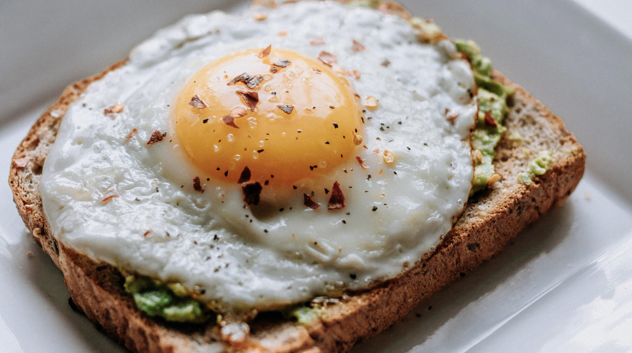 Bread, avocado and fried egg on the top