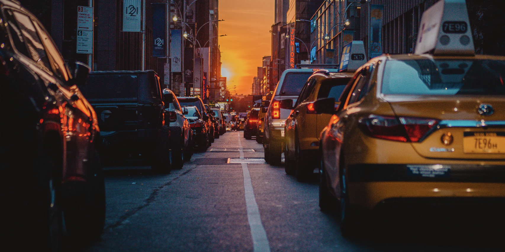 A street view, cars on the road, sunset background