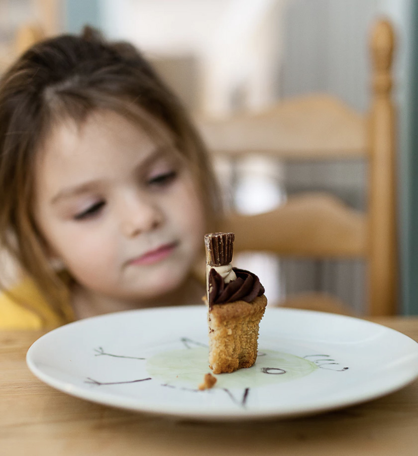 A child with a half cupcake