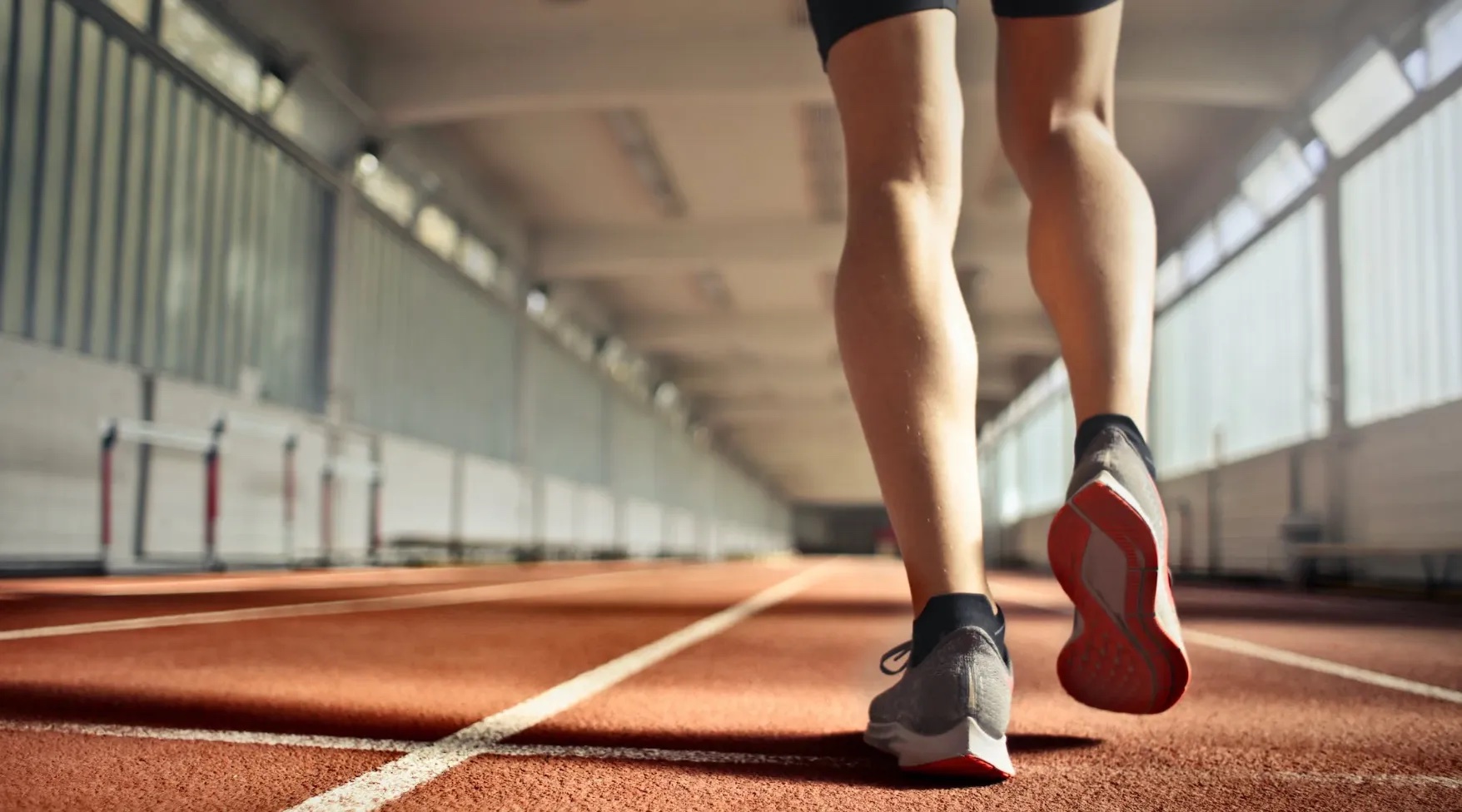 Someone running on a running track.