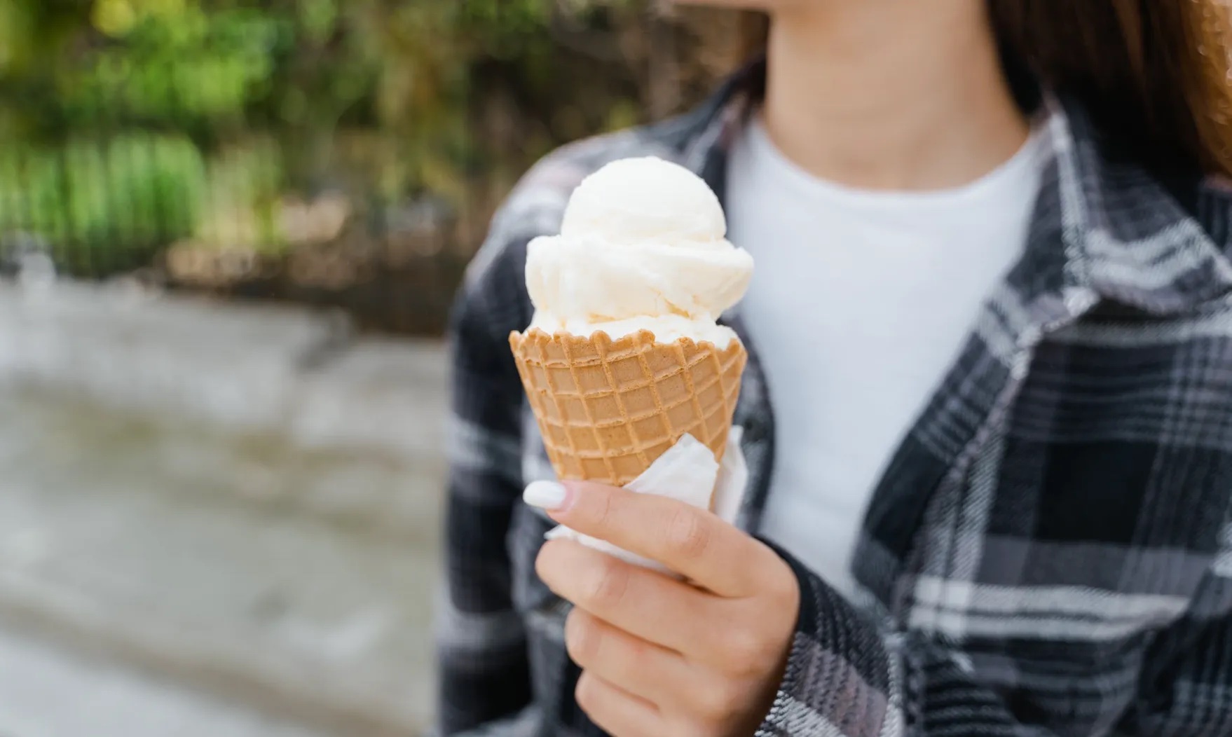 Woman holds an ice-cream.