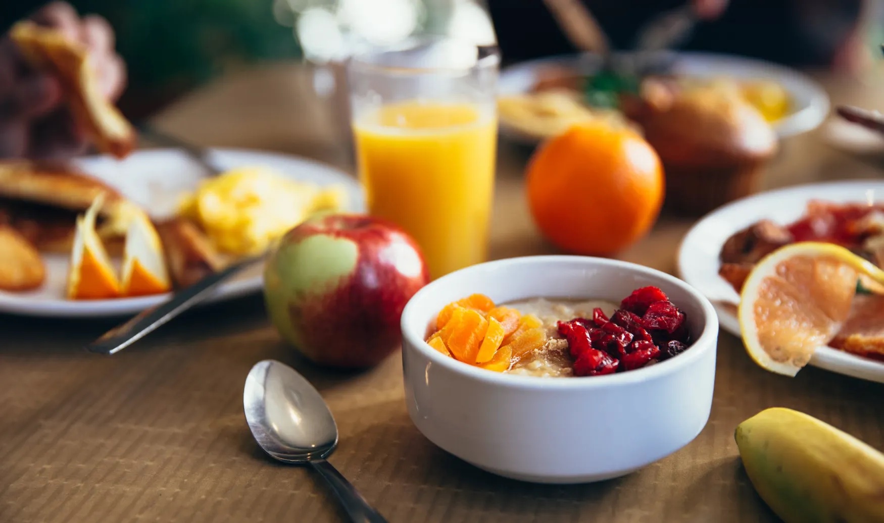 There are different foods on a table, mainly fruits.