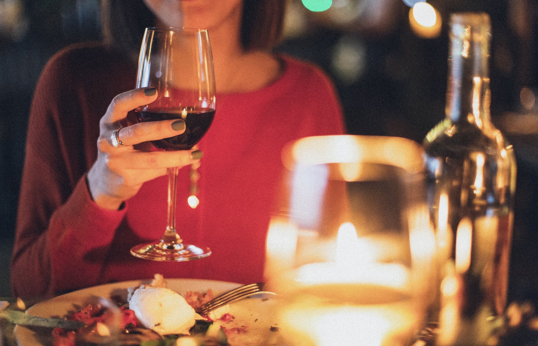 woman holding glass of wine