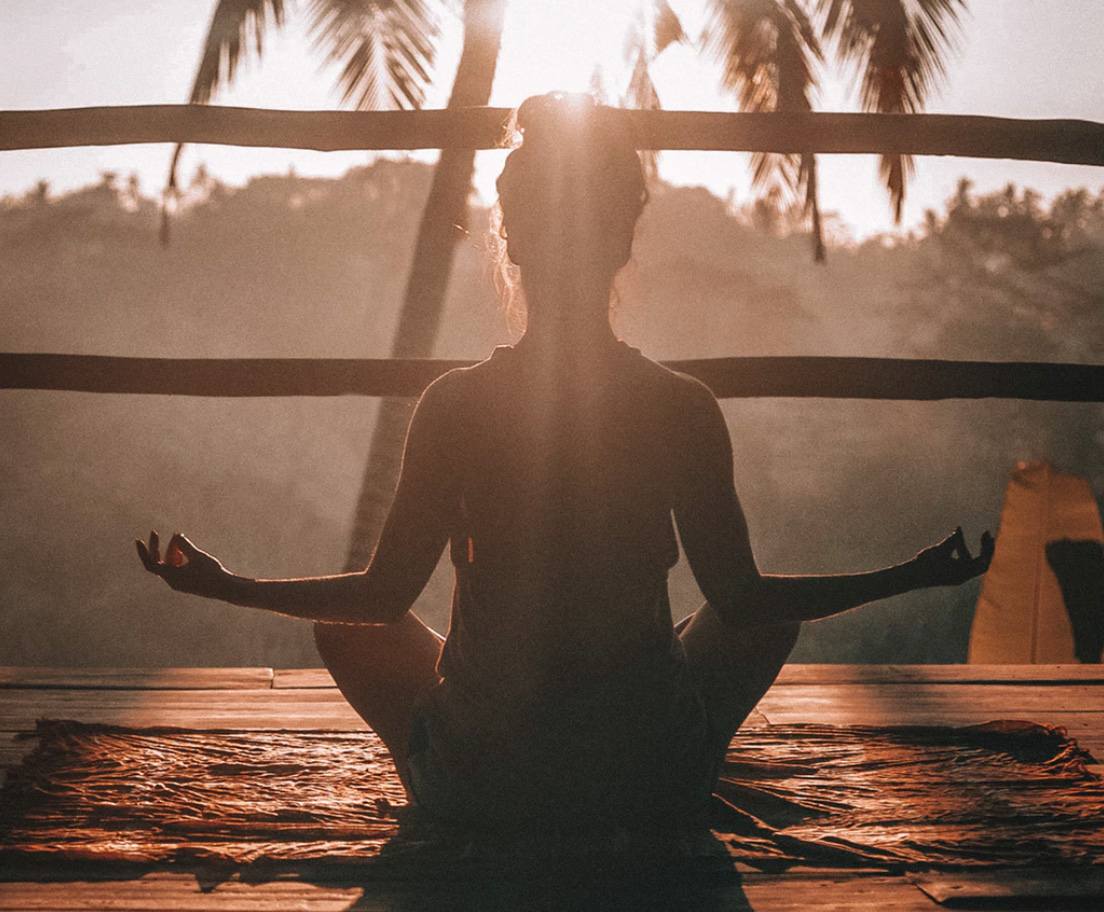 Girl meditating during sunrise