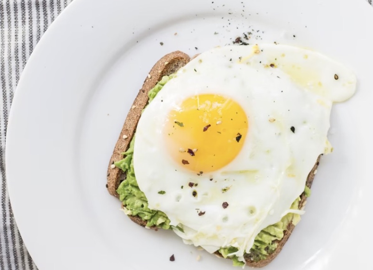 Avocado toast with a fried egg on top.