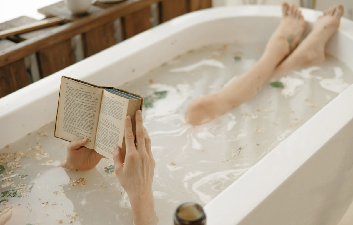 Woman reading book in bathtub. Image: Pexels - Yaroslav Shuraev