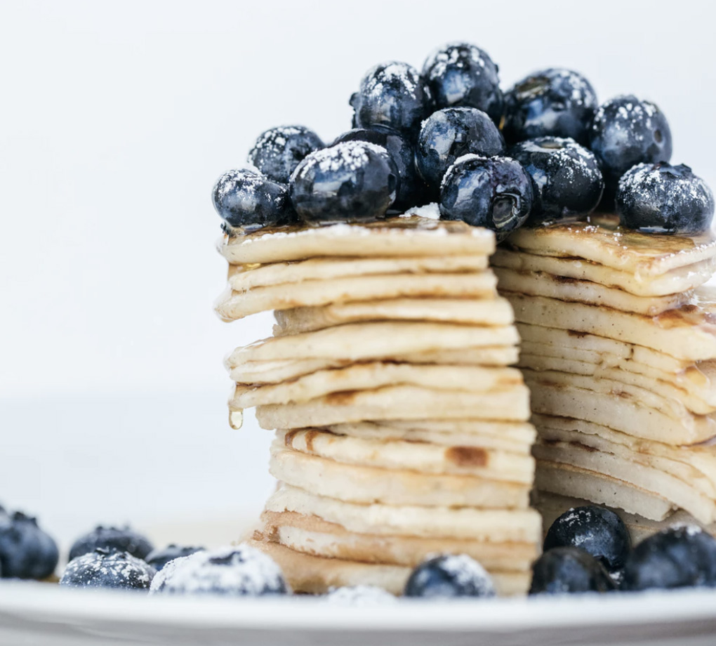 A stack of pancakes with blueberries on top