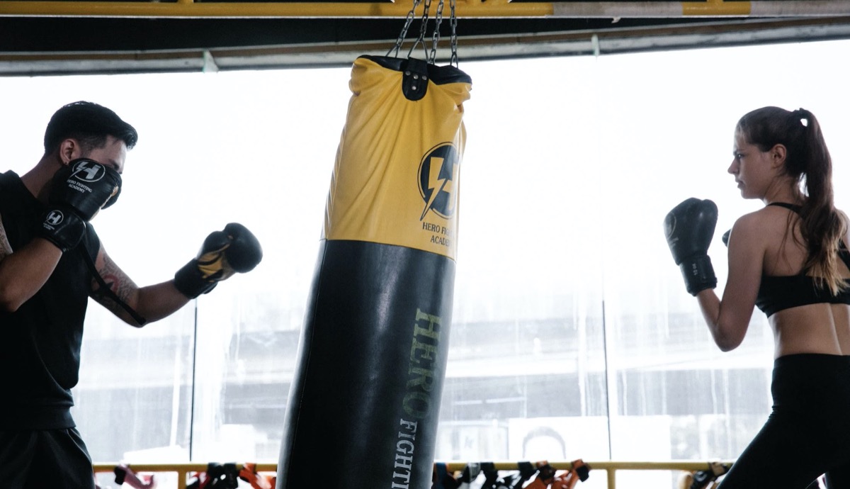 Two individuals boxing with boxing bag. Image: Pexels - Annushka Ahuja