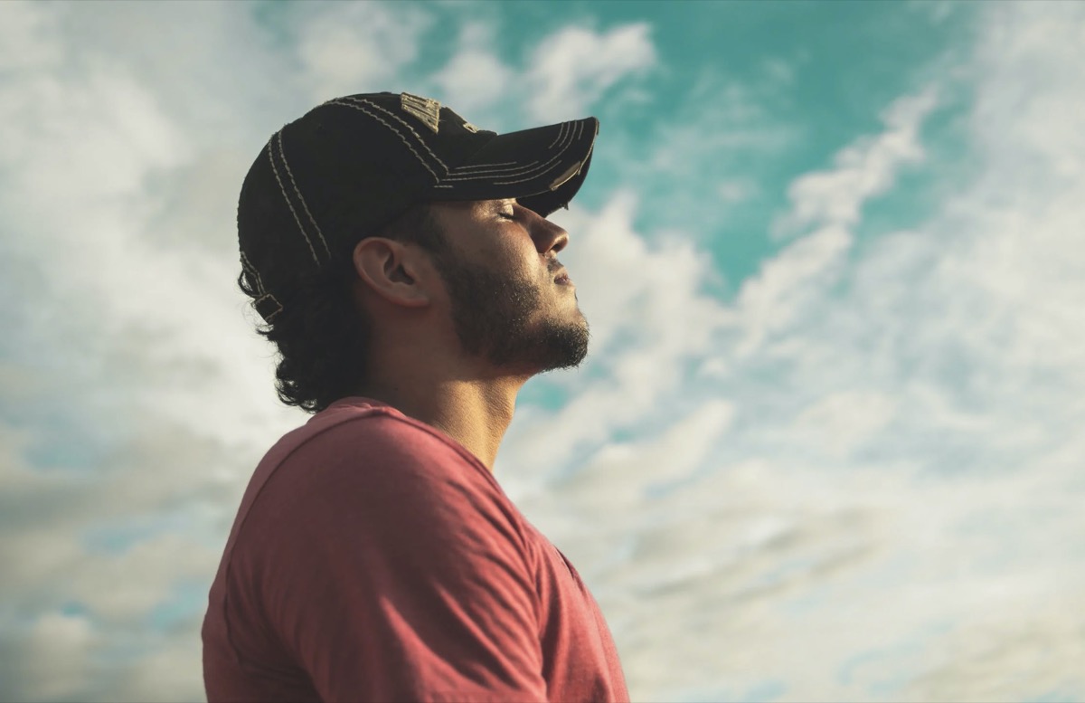 Man standing outside breathing