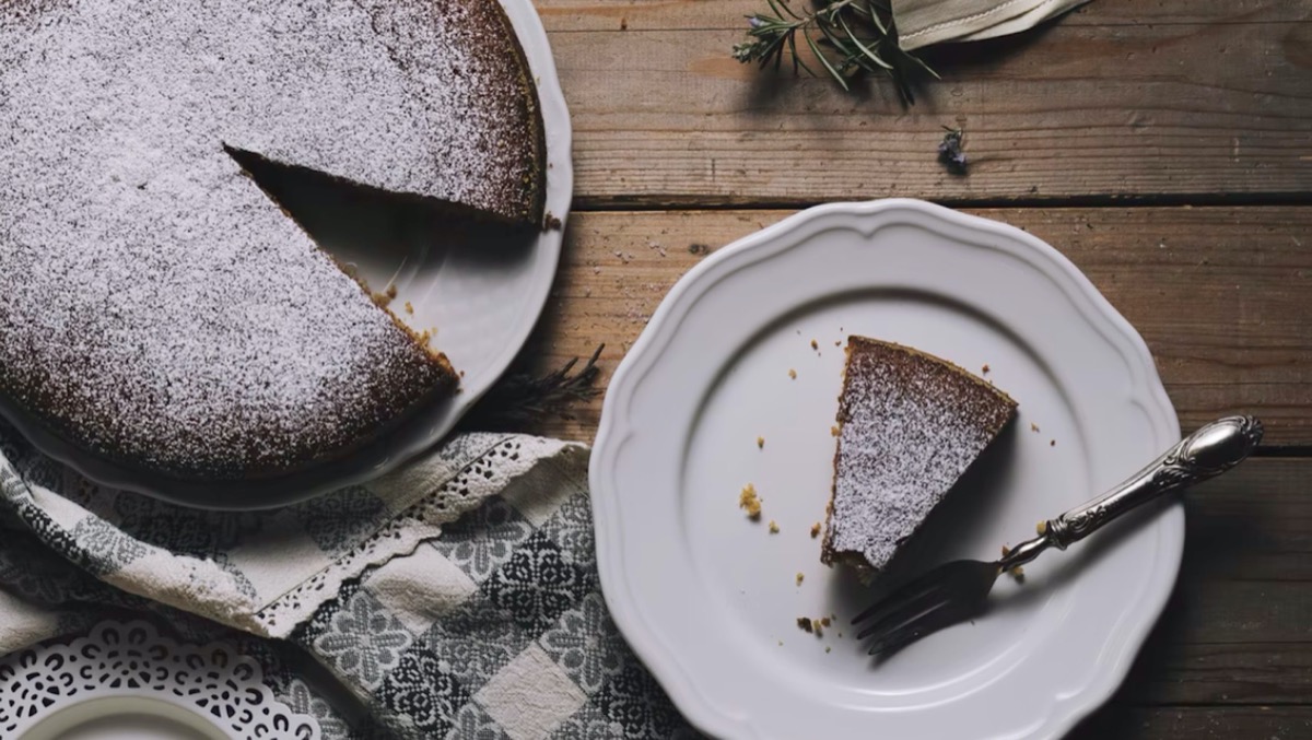 Chocolate cake with a slice cut out. Unsplash - Henry Be