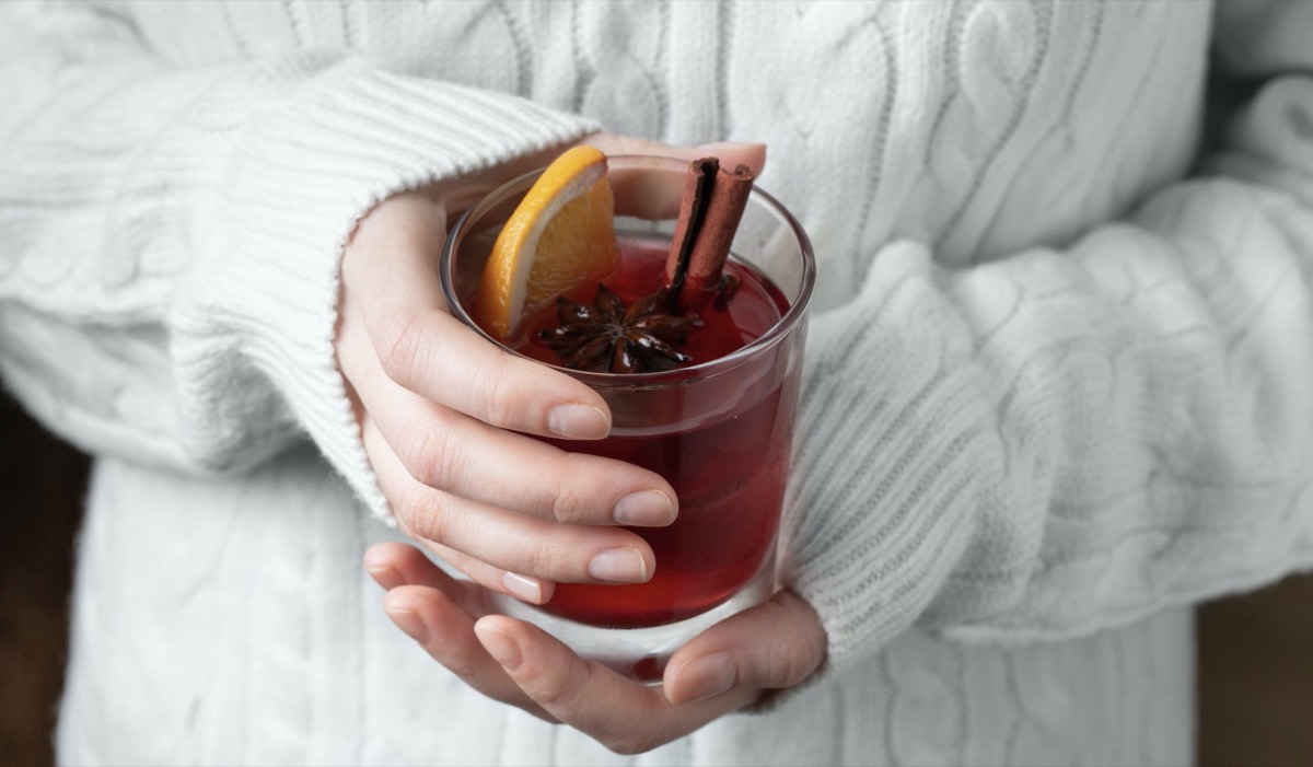 Woman holding drink in hand. 