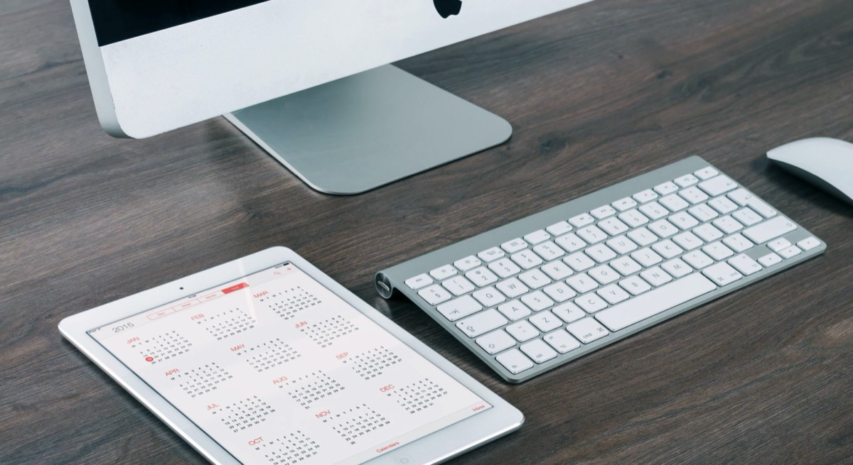 Work table with computer and calendar.