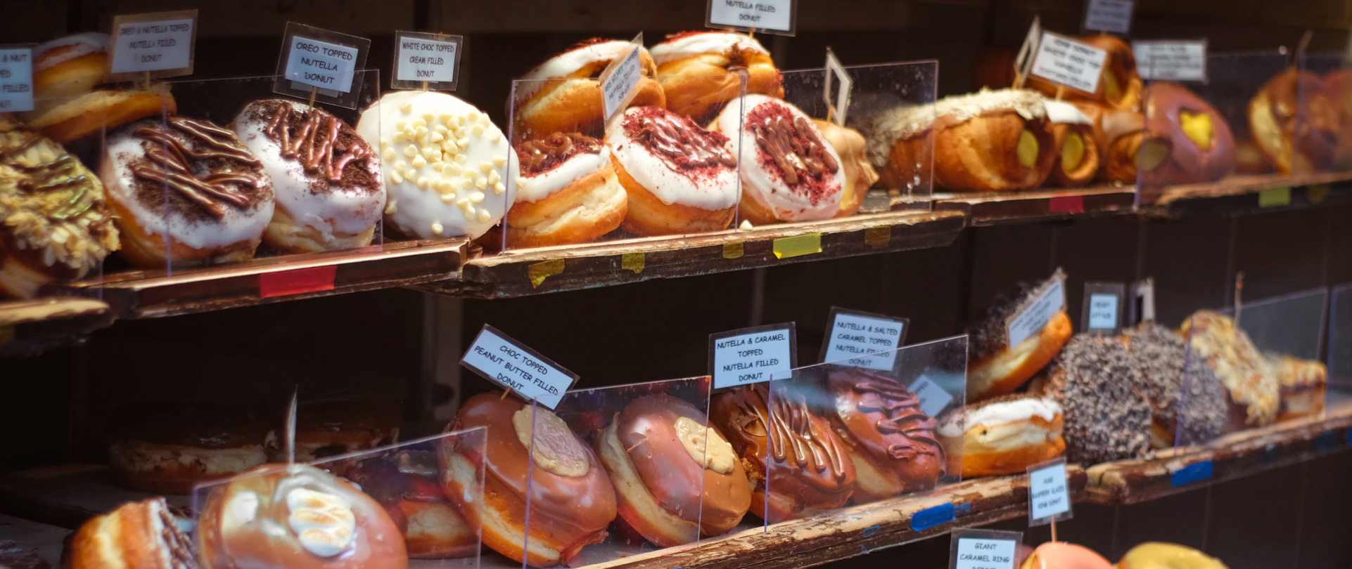 Donuts at doughnut shop. Unsplash - Viktor Forgacs
