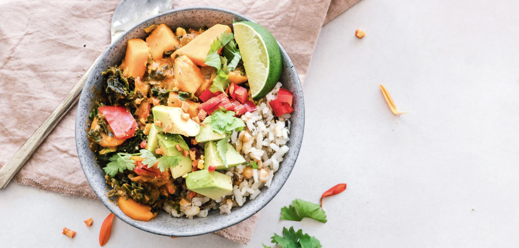 Bowl of food with colorful veggies 