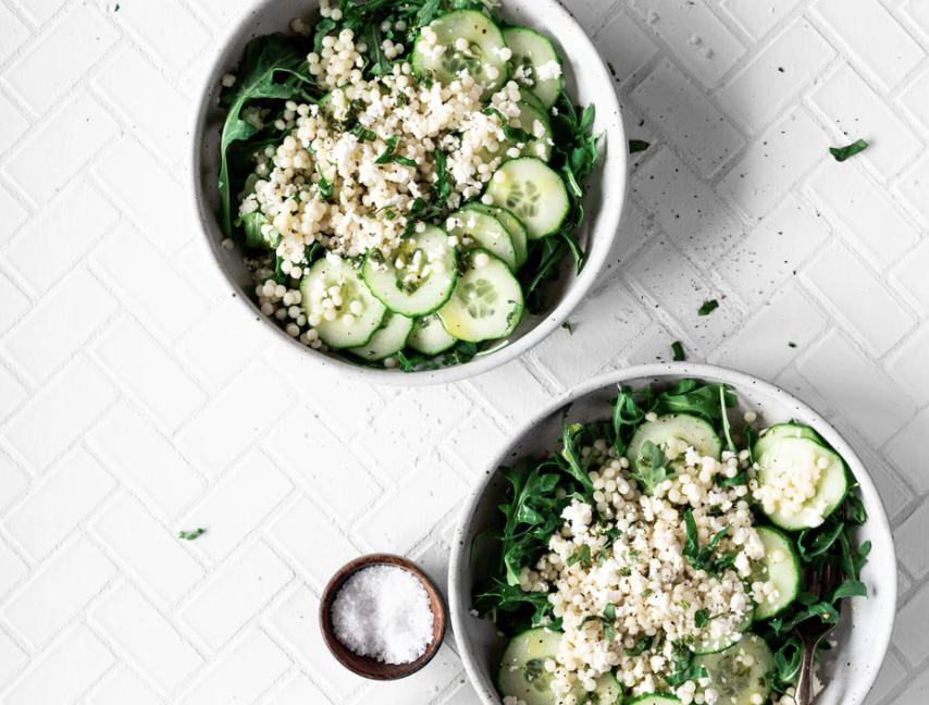 A bowl of cucumbers and spinach as a salad