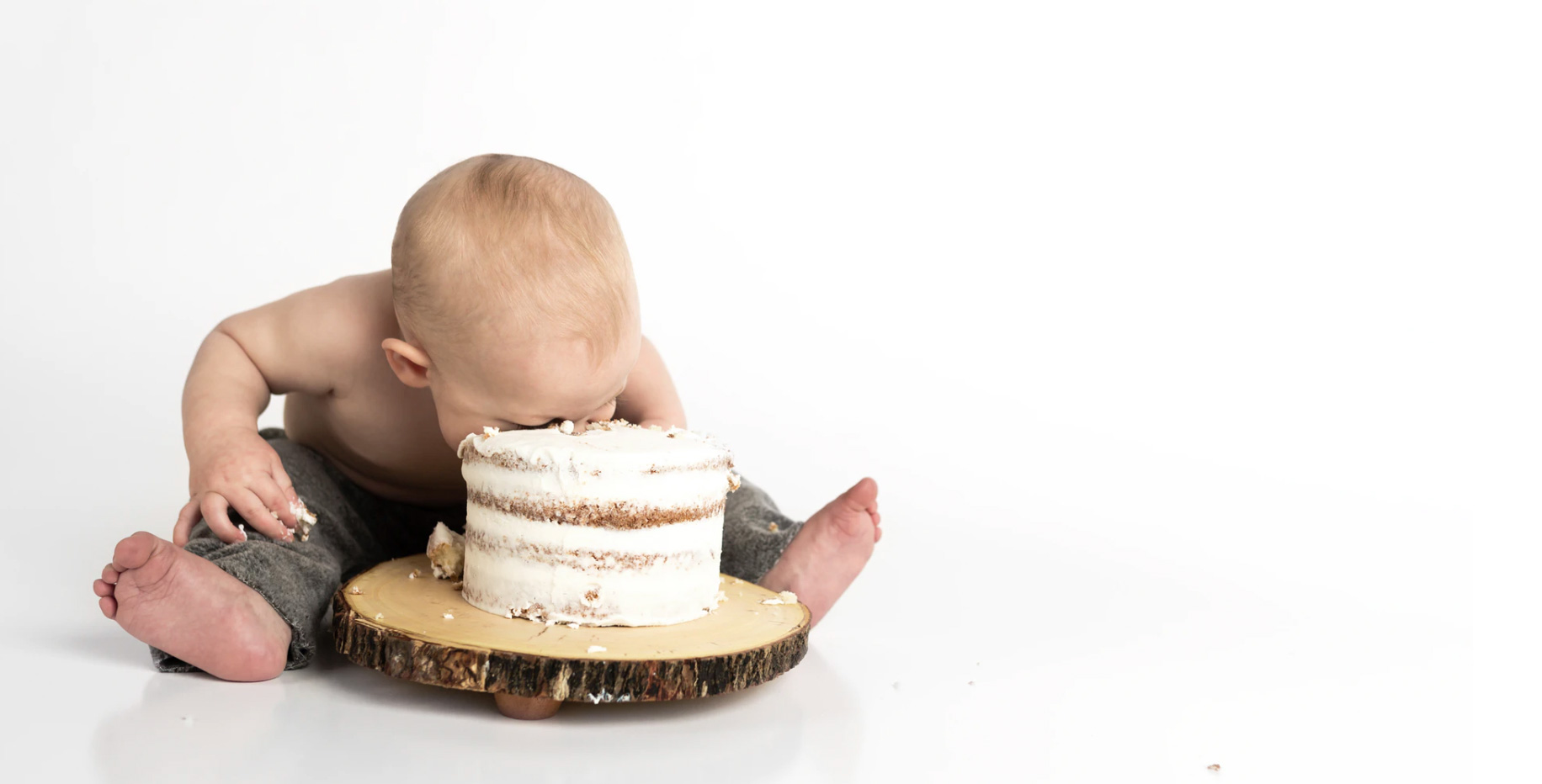 Child eating cake and digging head into it 