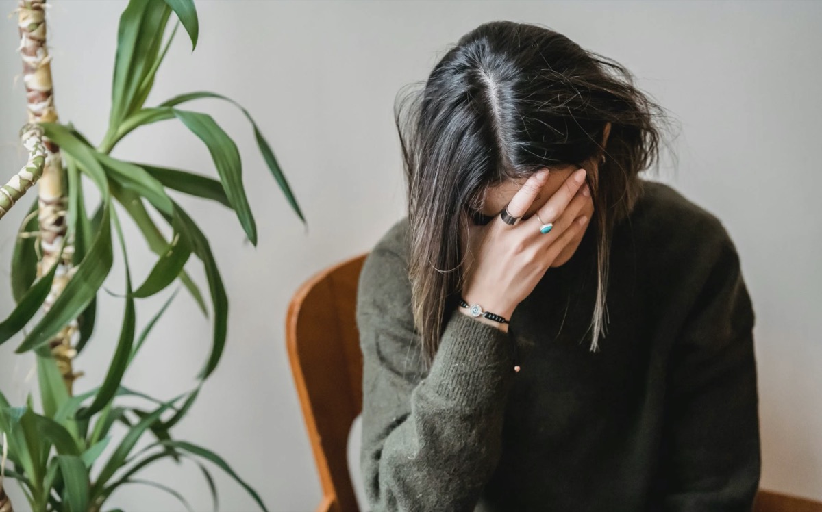 Woman feeling emotional with head down. Image - Pexels: Liza Summer