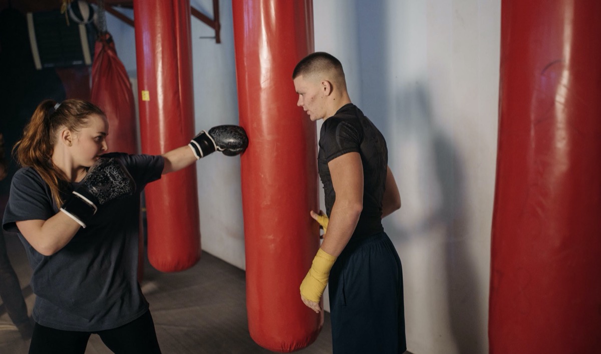 Woman boxing with an instructor
