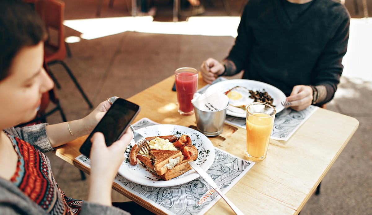 Woman taking photo of food