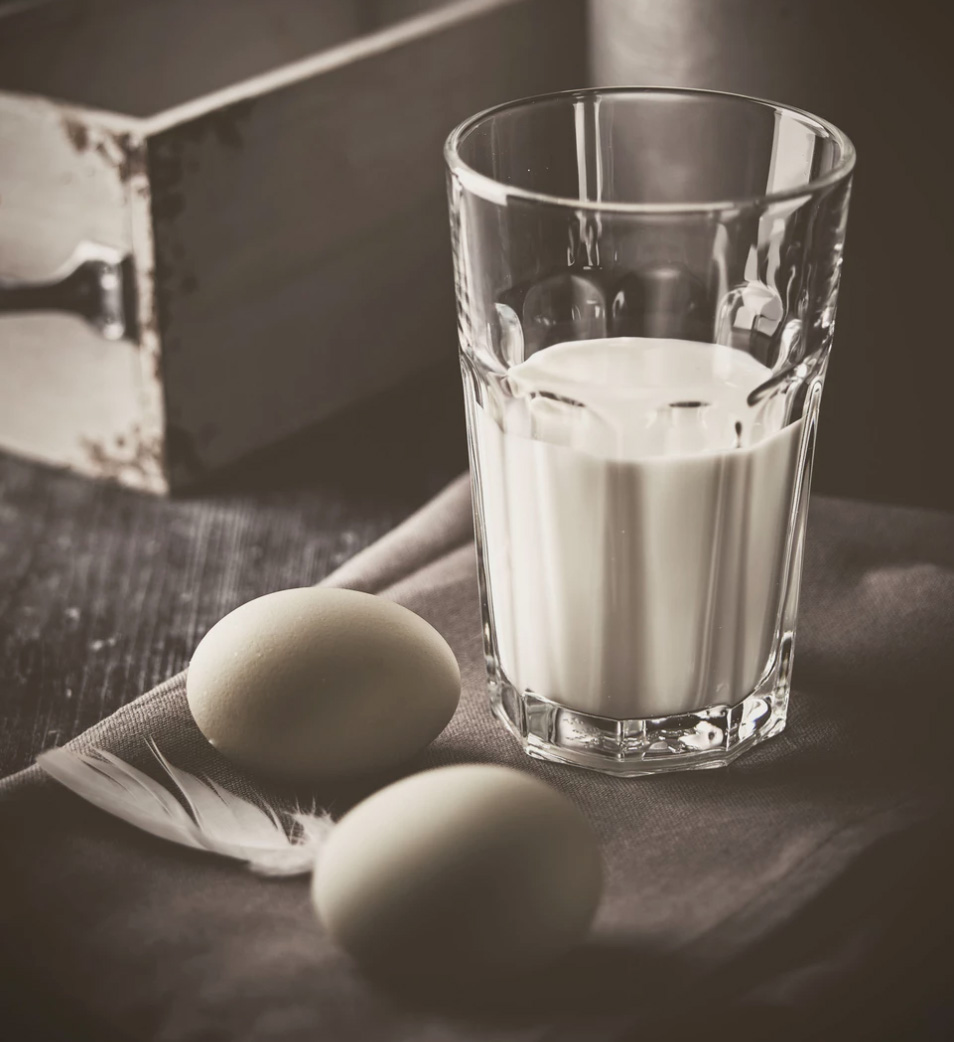 A glass of milk and two eggs to portray common food sensitivities