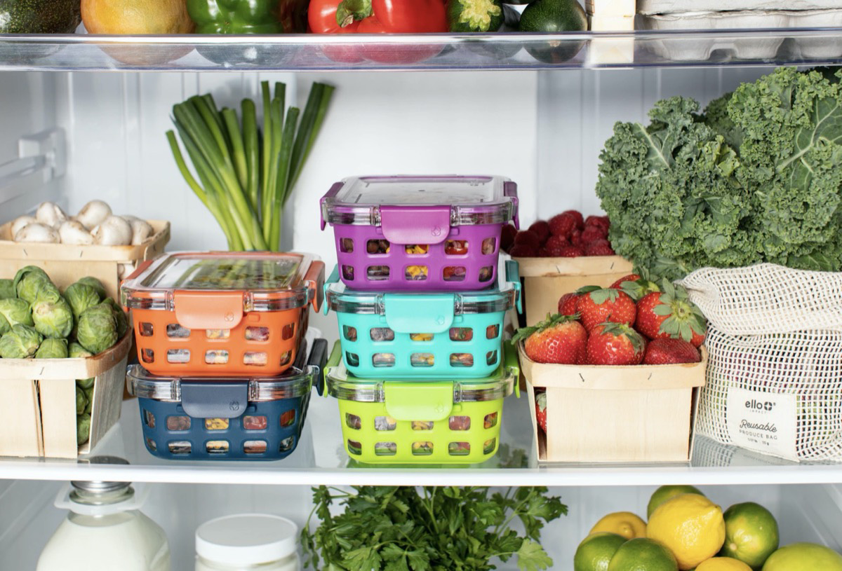 Inside of an organized fridge with fruits and vegetables.
