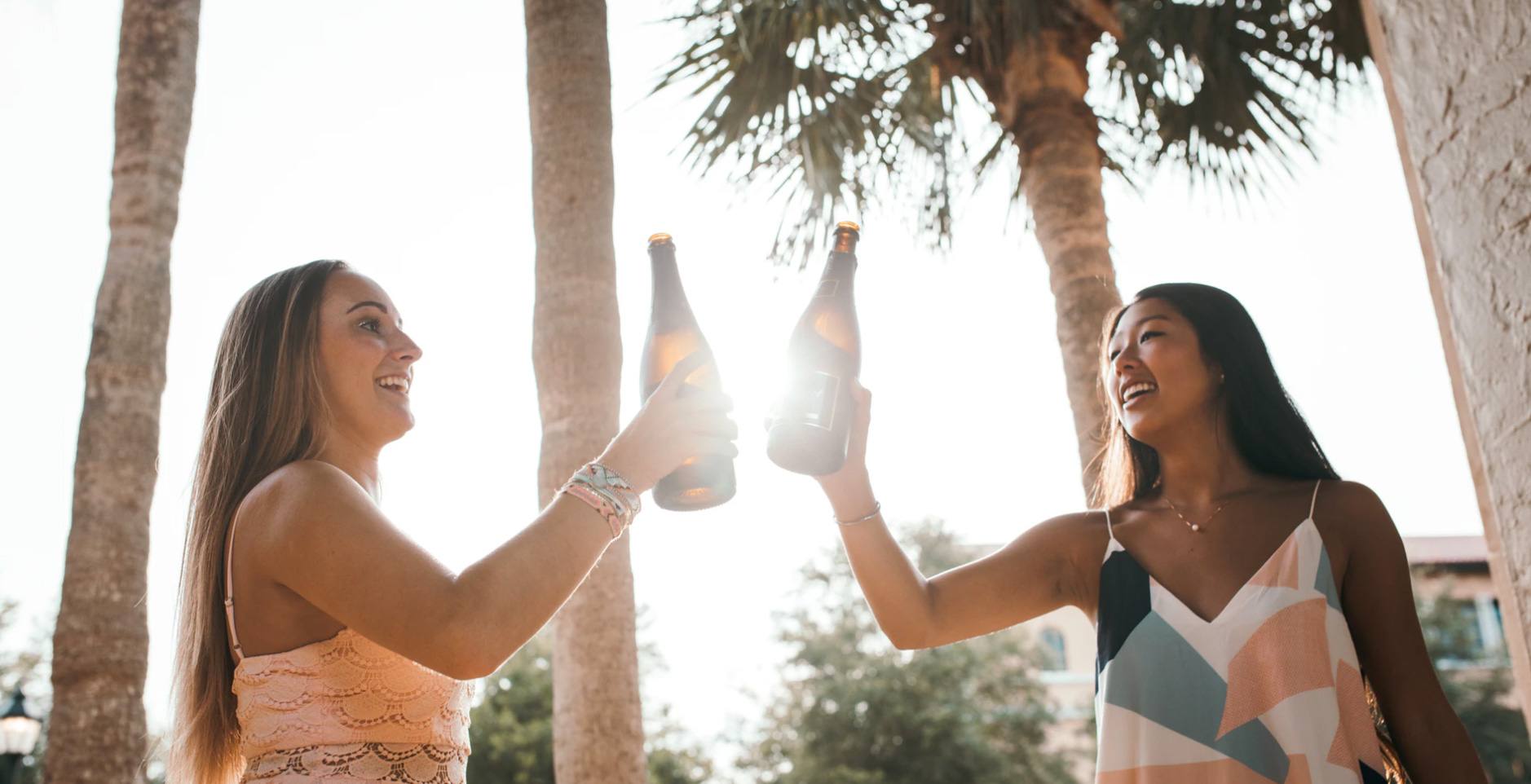 Two girls enjoying a drink. Unsplash: Kal Visuals 