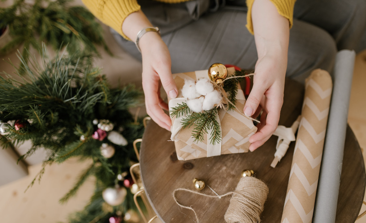 Woman wrapping holiday presents. Image: Pexels - Julia Volk