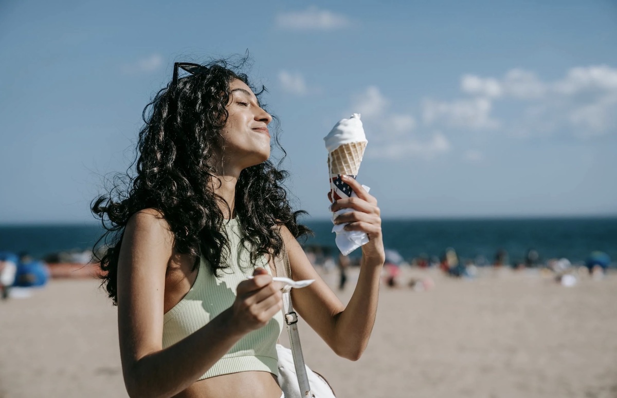 Woman enjoying and eating ice cream. Image: Pexels - Katya Wolf