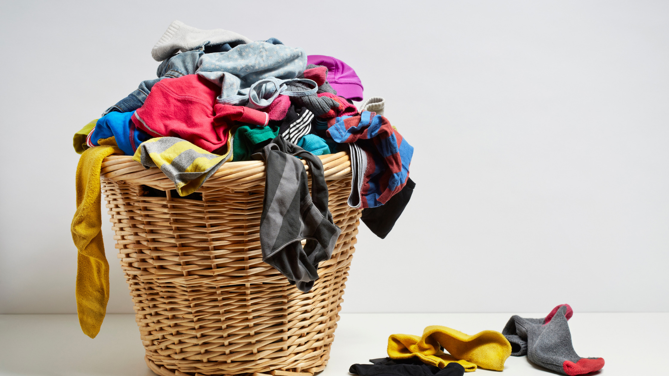 laundry basket filled with dirty clothes 