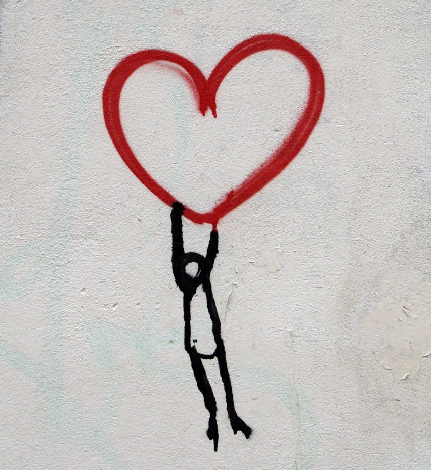 Drawing of person hanging onto a heart 