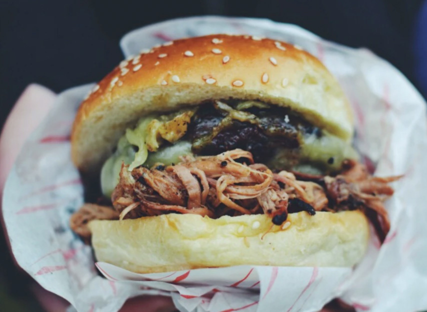 A burger filled with meat and pulled pork. 