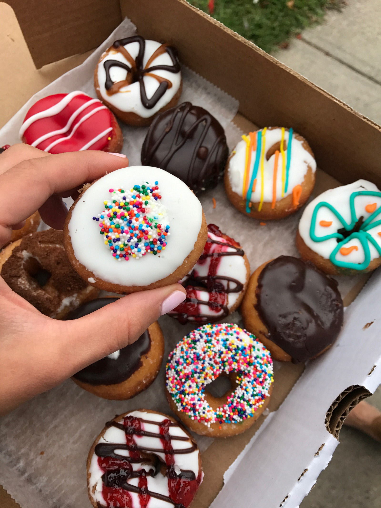 A box of mini donuts of all different flavors. 