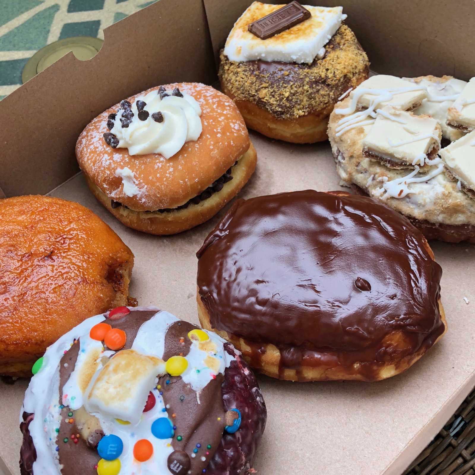 A box of 6 donuts of all different flavors from Crazy Donuts in Connecticut.