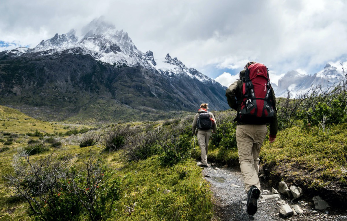 Two individuals climbing a mountain. Unsplash - Toomas Tartes