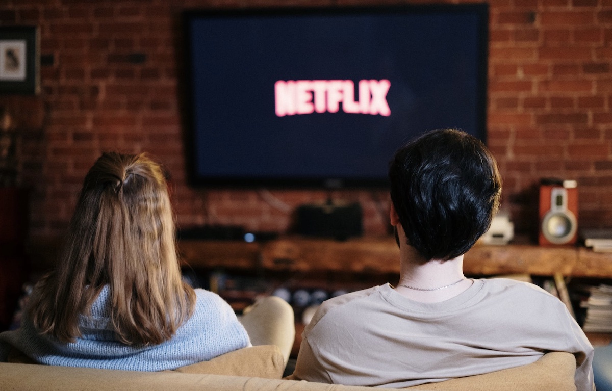 Man and women watching netflix at night on couch