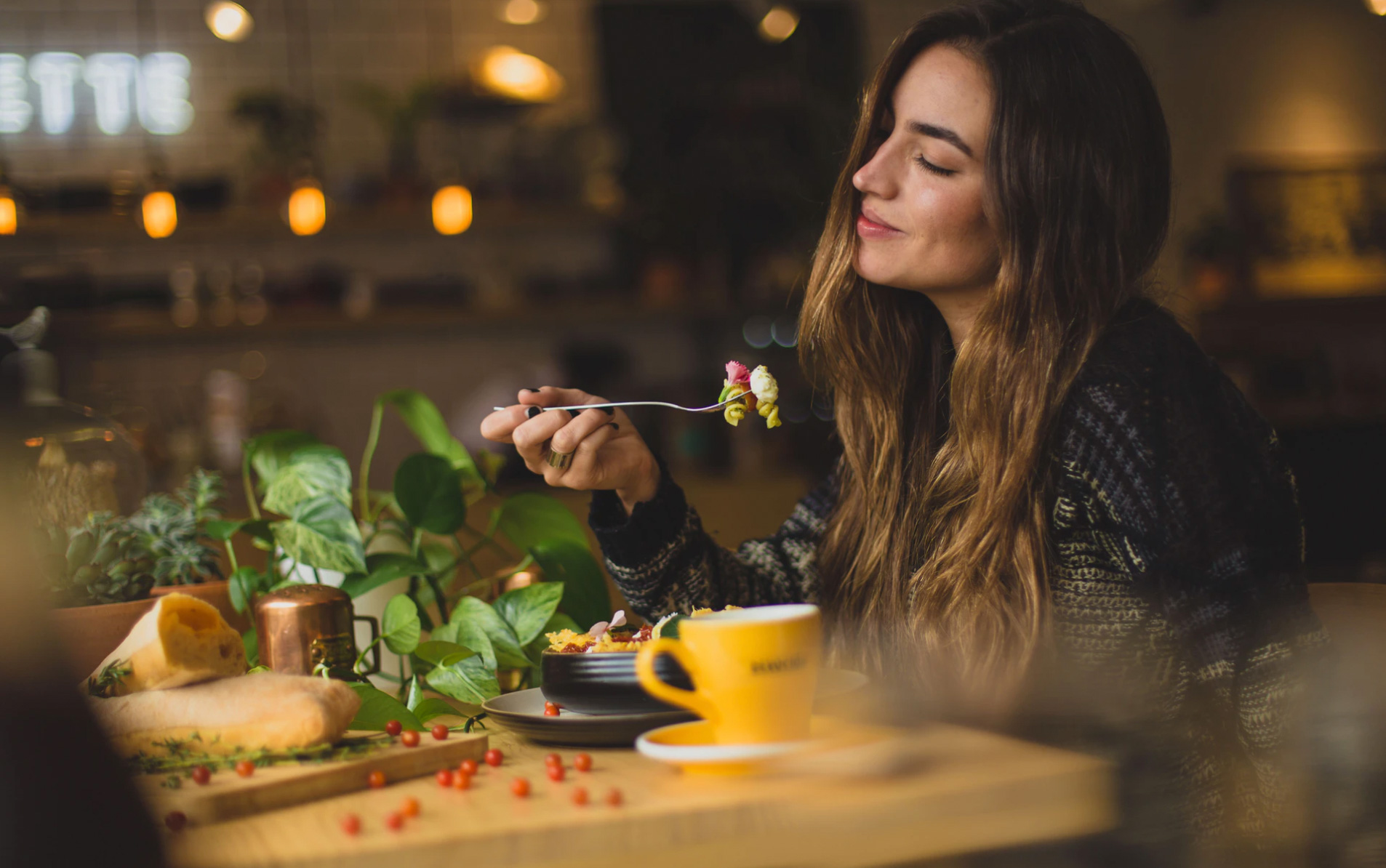 Girl enjoying her meal at the table 