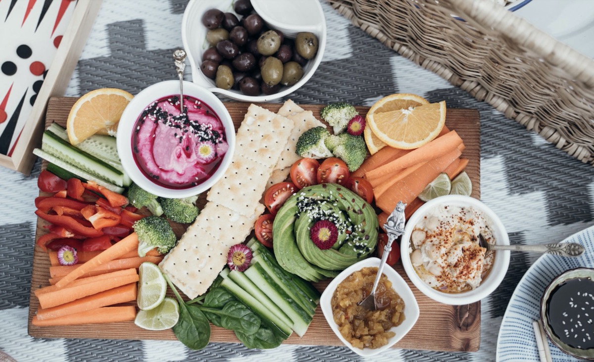 Picnic spread on a wooden board with friends