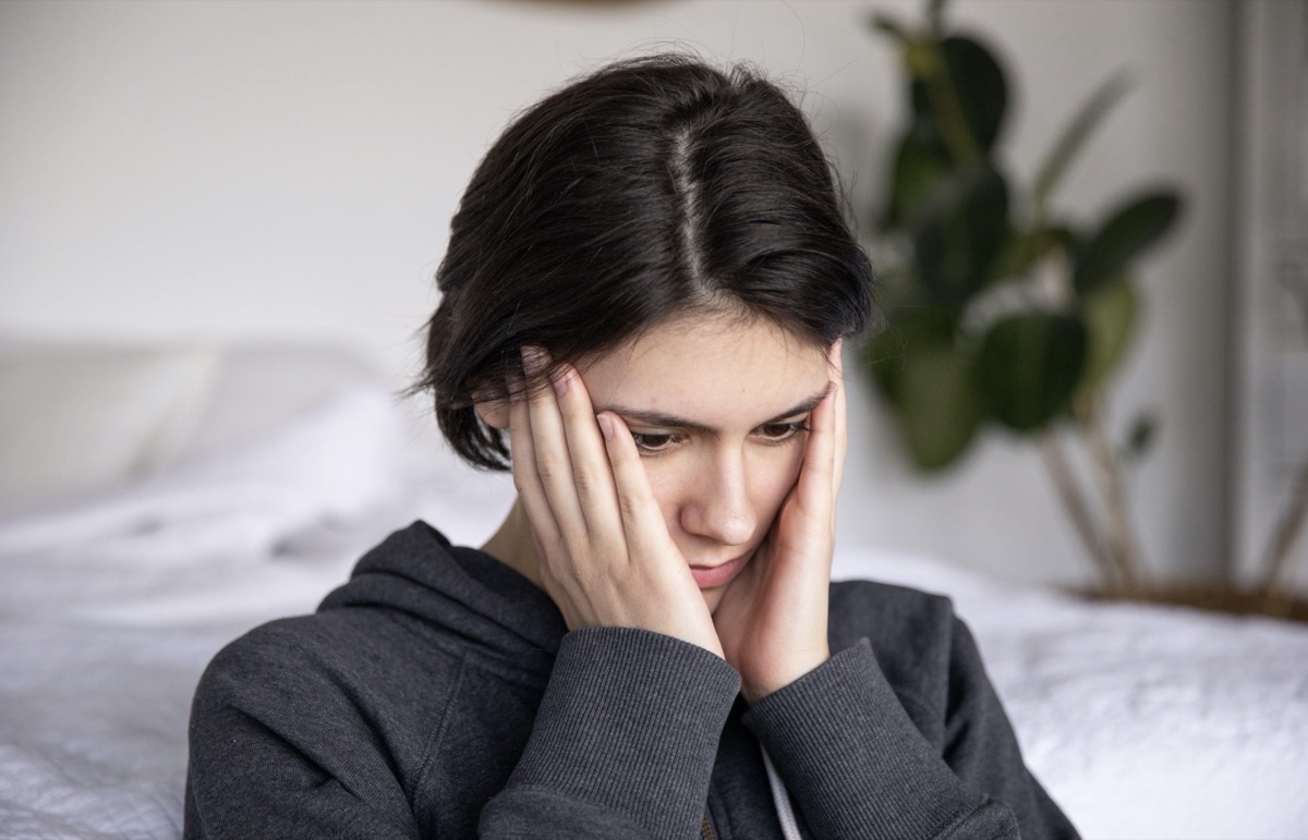 Woman in her thoughts holding her head.