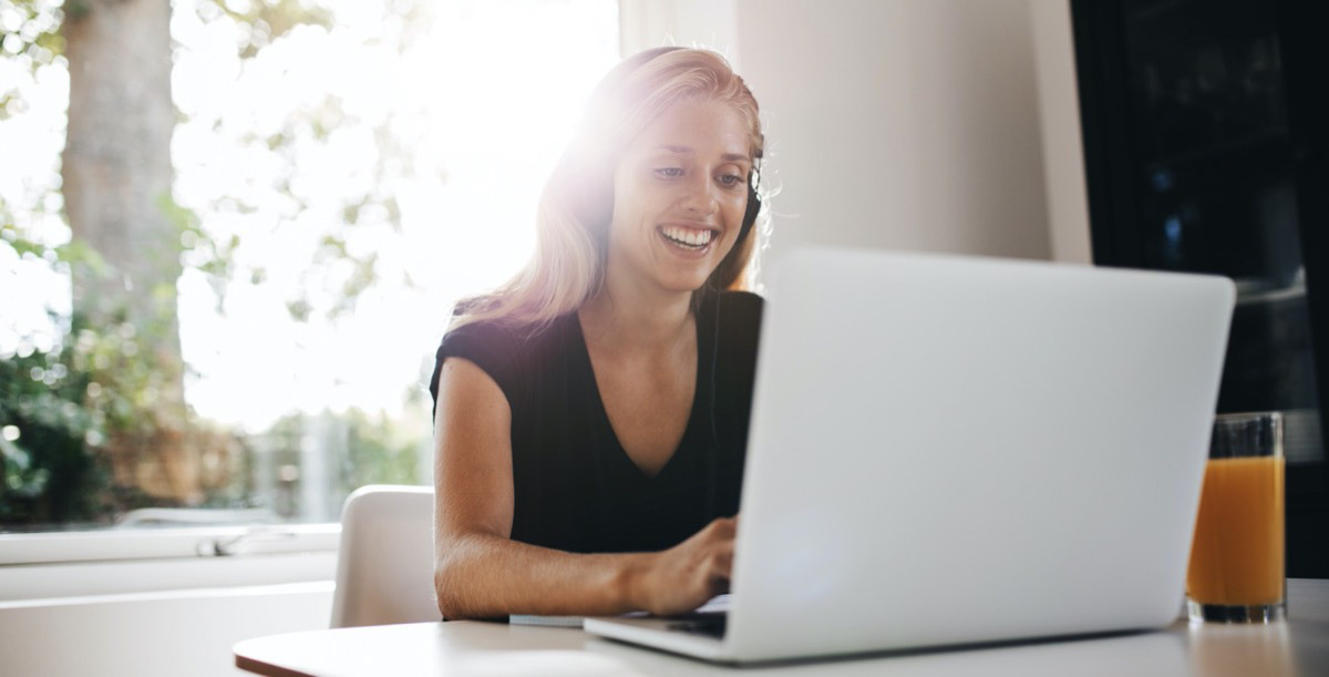 Woman working in front of laptop and smiling
