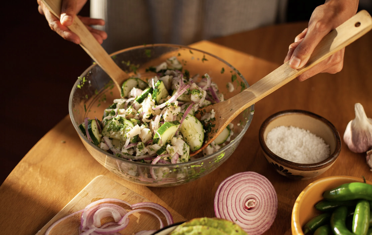 Mixing together salad. Image: Pexels - Los Muertos Crew