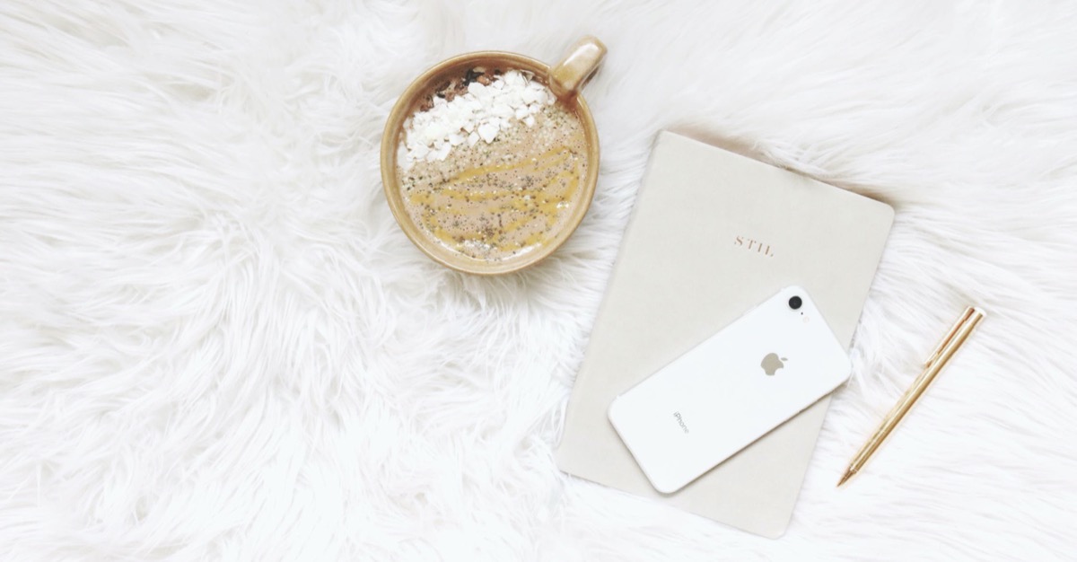 A bowl of oatmeal with phone and journal. Pexels - Madison Inouye