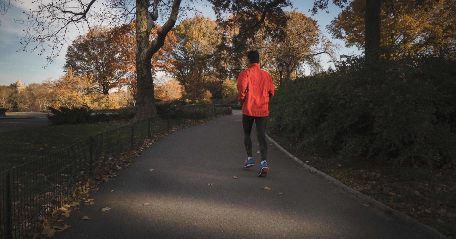 Man running in a park while social distancing due to COVID19 but still exercising. 