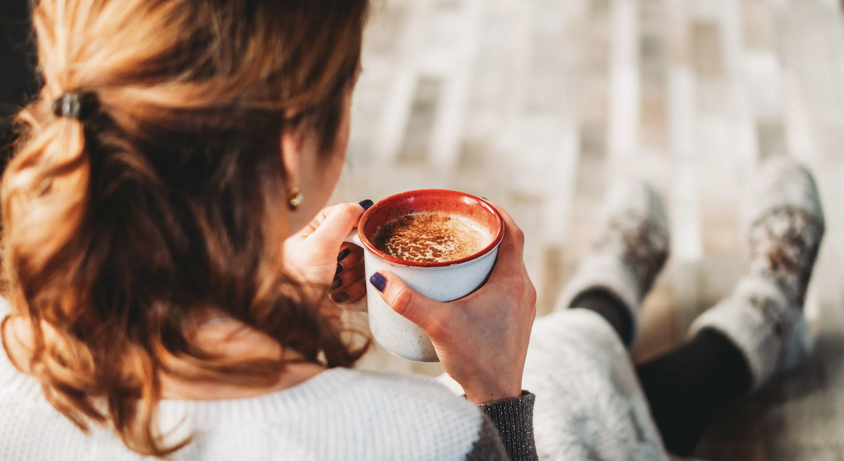 Girl drinking from a mug. Image: Pexels - Chait Goli