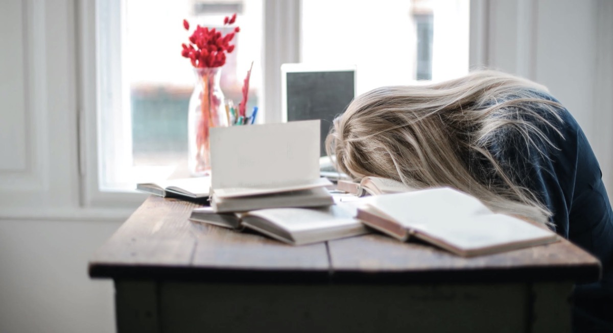 Woman sleeping at desk with laptop. Image: Pexels - Andrea Piacquadio