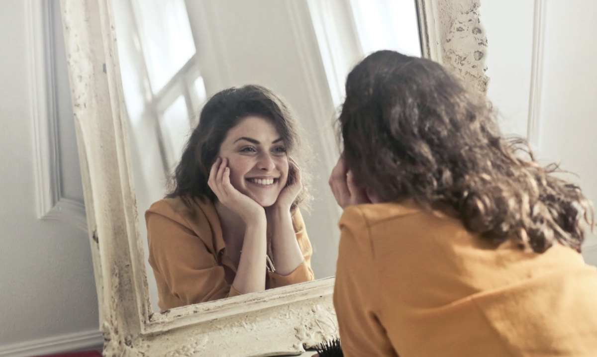 Woman looking in the mirror. Image: Pexels - Andrea Piacquadio