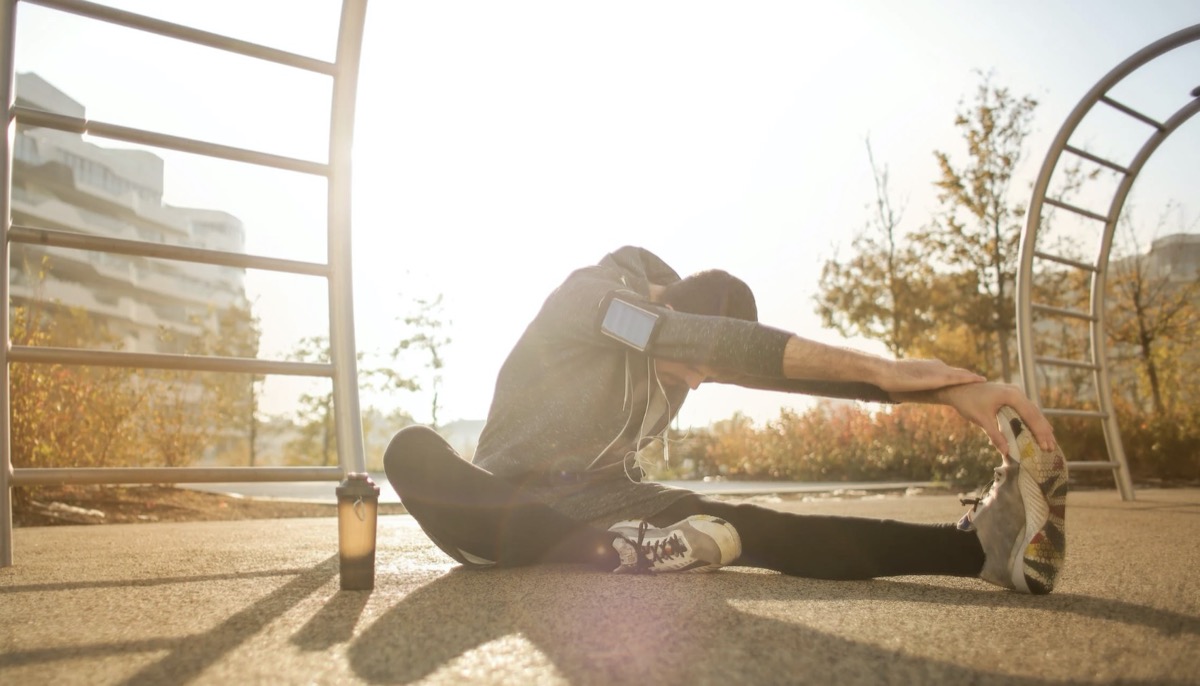 Woman stretching. Image: Pexels - Andrea Piacquadio